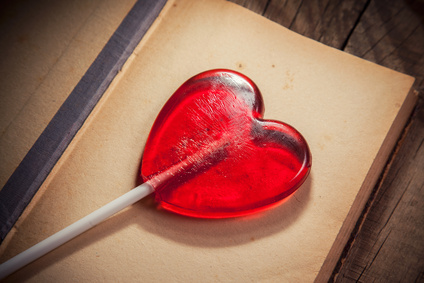 Lollipop heart on vintage wooden background