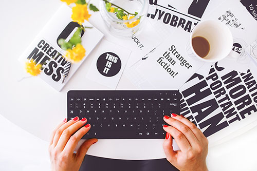 Hands typing on a Keyboard