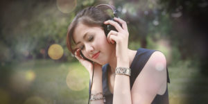 Image of a woman listening to an audiobook