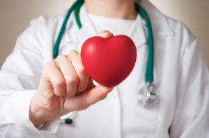 doctor holding a heart to show medical romance